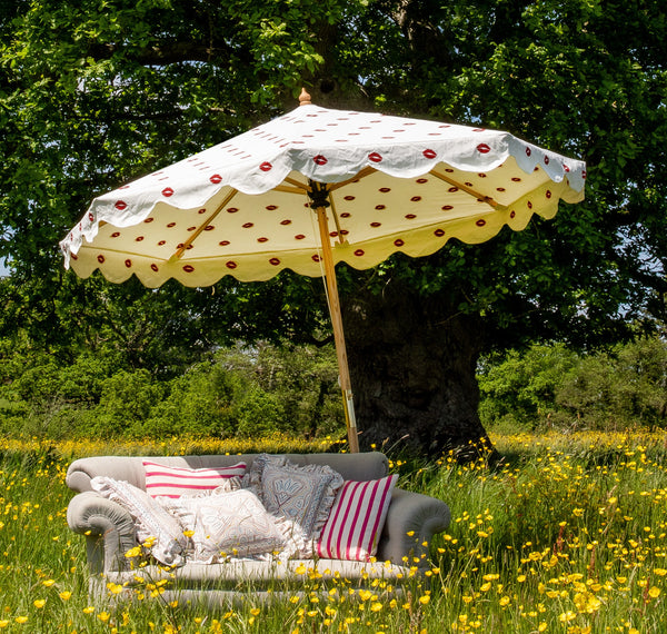 Big Iain 1 Octagonal Parasol in a field with a couch in the sun
