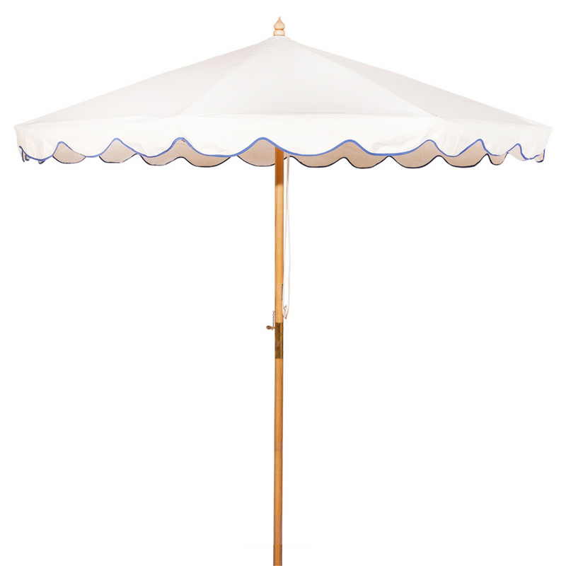 Blue Holly- Handcrafted frame made in the UK. Beautiful plain natural white parasol with blue scallop edged. Simple, chic and elegant. FSC certified ash frame made in Hampshire with our own designs of brass fittings and pulleys. A parasol perfect for a picnic, patio, through your table with an umbrella hole or by your sun lounger at the pool.