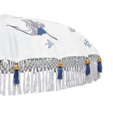 East London Parasol Company Bali Bamboo 2m garden umbrella. Flying birds cranes with white, blue and indigo. Handmade and handpainted with fringing and tassels in shades of white