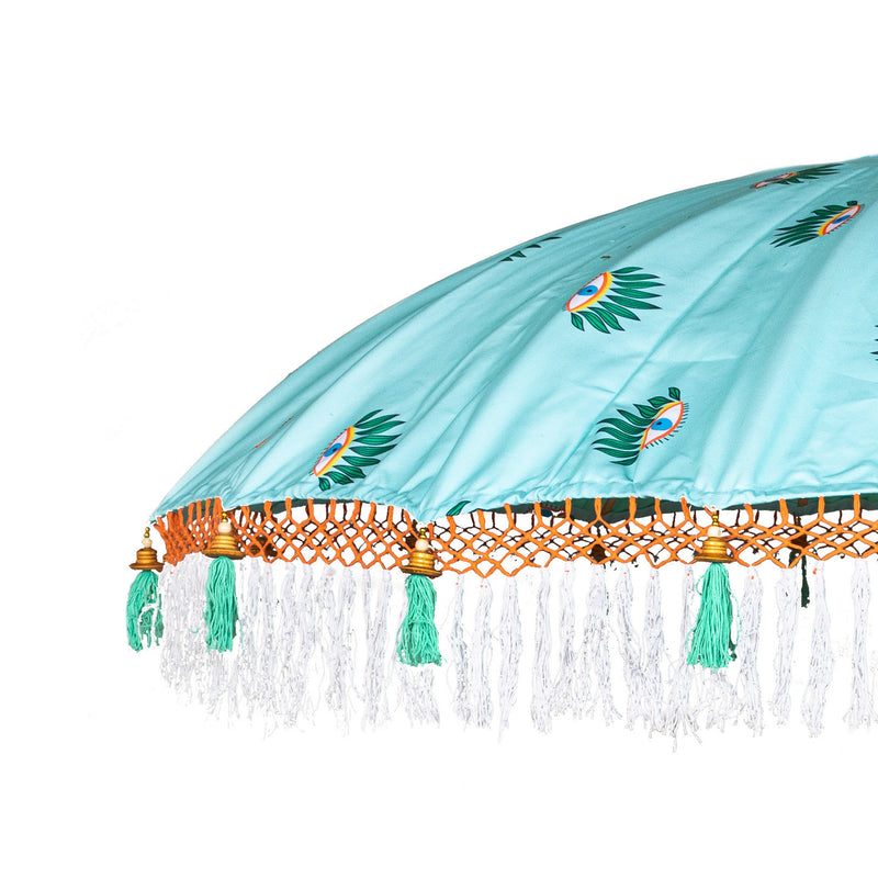 Catherine Round Bamboo Parasol has an evil eye printed canopy on turquoise with orange threading and white fringing. pole is made from hand-carved durian wood pole with gold paint and finial, the pole join and pegs are made from solid brass.
