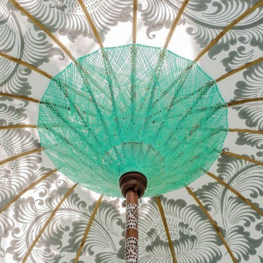 Cher white cream silver and mint green blue  garden parasol or umbrella hand painted with silver. Bamboo spokes, hand carved durian wood pole, Indian metal silver fringing and light blue cotton tassels. Pretty garden umbrella for picnics, gardens, festivals, weddings, terraces and pool side. Beautiful boho, bali parasol.