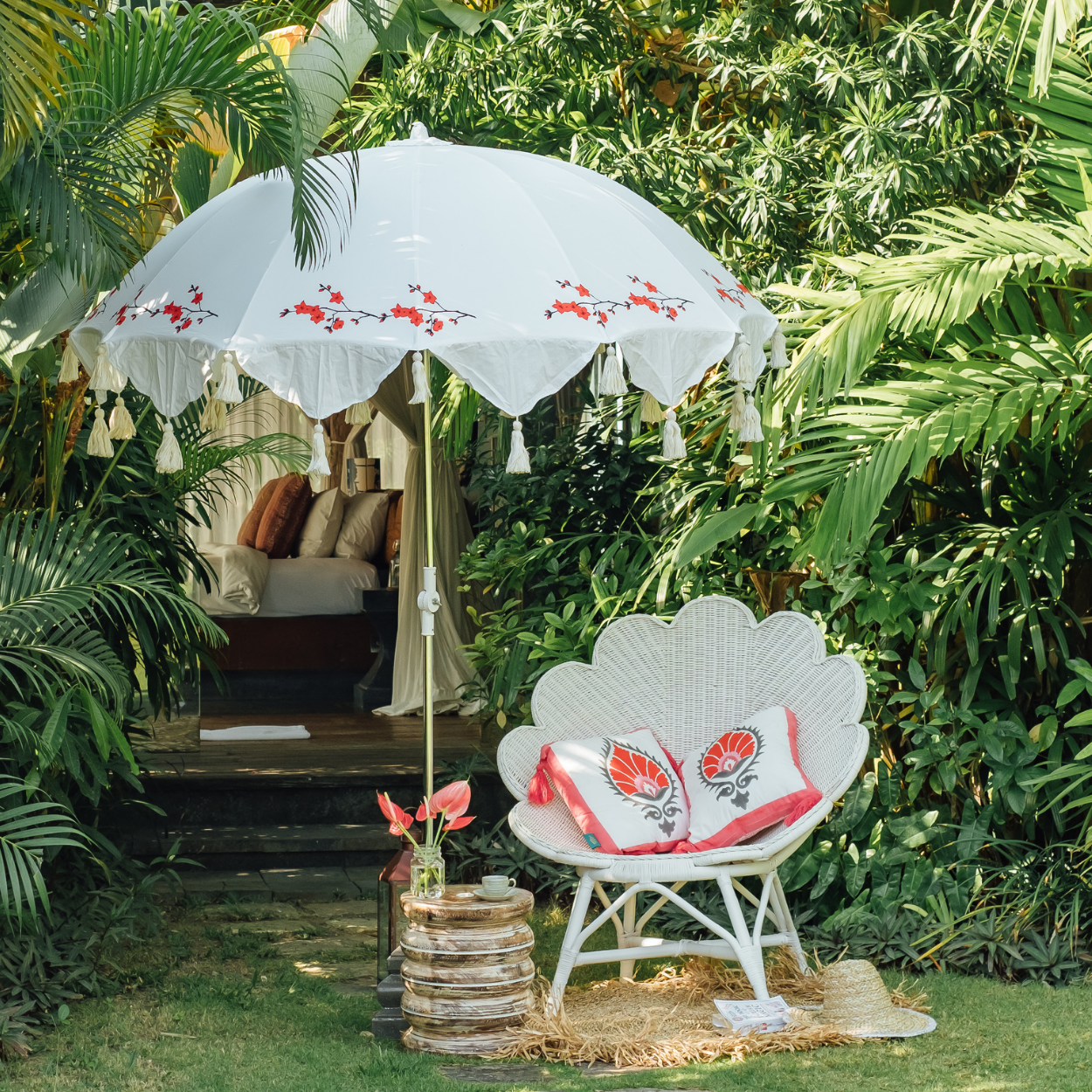 Handmade pink, red and grey block printed cotton cushion with vibrant tassels, garden cushion to match our beautiful garden umbrellas. Vibrant and colourful garden decoration and parasols inspired by India and contemporary design.