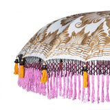Helena Round Bamboo Parasol - soft beige twill with lotus design hand-painted in gold ink. Inside the threading is vibrant tangerine orange, and the fringe is a combination of peony pink, black and orange tassels.