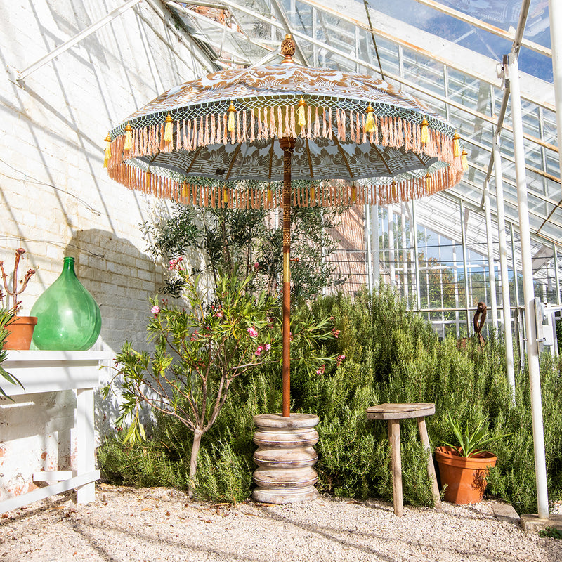 Hugo Round Bamboo Parasol lifestyle shot inside a greenhouse- highlighting the pastel beauty.