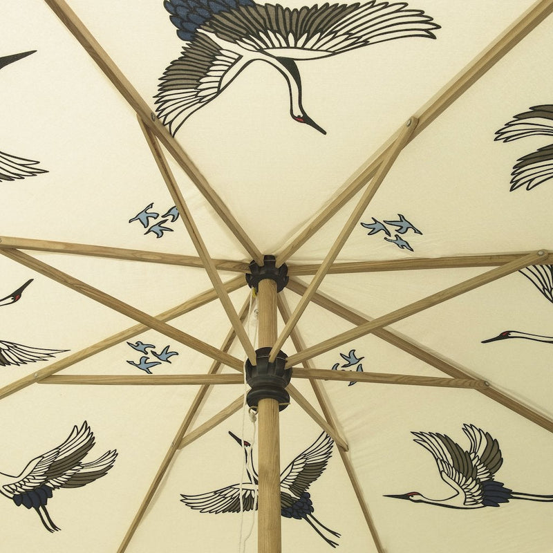 Big Lexi, 3m width waterproof canvas Garden parasol in natural cotton  with flying birds in grey, red and indigo blue on the inside. Screen printed garden umbrella with stunning indigo tassels. Elegant, chic and calming, the ultimate luxury garden decoration. The canopy is easily removable. The perfect umbrella for gardens, summer, patios, pool side and terraces. A fabulous garden accessory for a party.