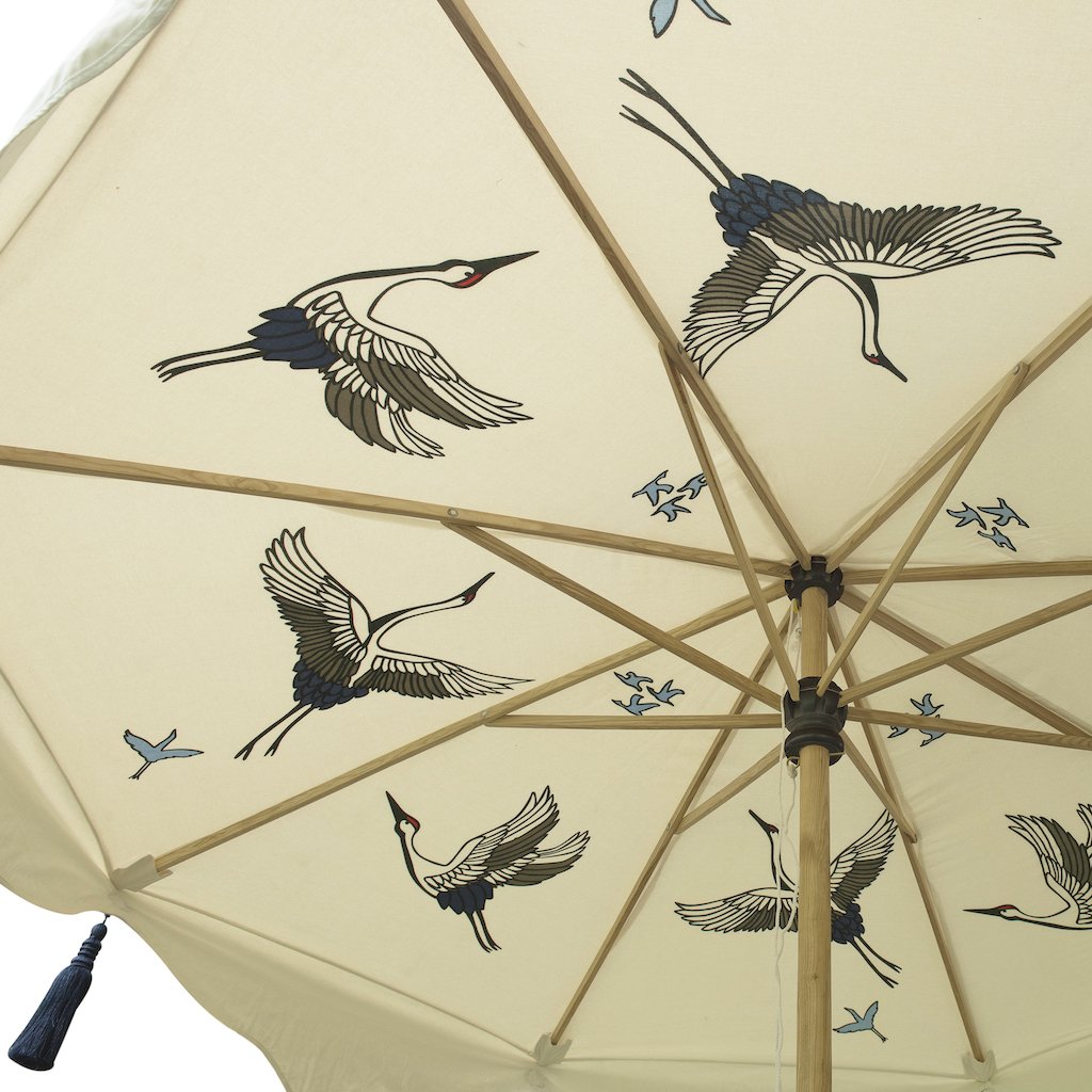 Big Lexi, 3m width waterproof canvas Garden parasol in natural cotton  with flying birds in grey, red and indigo blue on the inside. Screen printed garden umbrella with stunning indigo tassels. Elegant, chic and calming, the ultimate luxury garden decoration. The canopy is easily removable. The perfect umbrella for gardens, summer, patios, pool side and terraces. A fabulous garden accessory for a party.