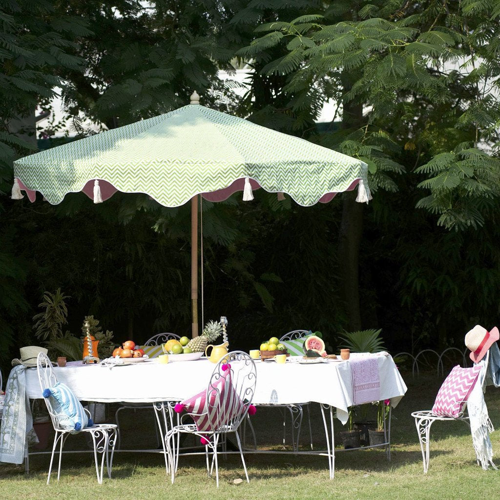 East London Parasol Company Big Green Aretha. 3m printed waterproof canvas green zigzag and pink wooden garden parasol. Different interchangeable covers available.  Printed green natural coloured waterproof cotton canvas garden umbrella with Jaipur rose pink underneath, Arabian-influenced fringe and natural cotton tassels. The perfect umbrella for gardens, summer, patios, pool side and terraces. Fabulous summer decoration.