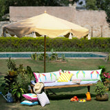 East London Parasol Company. Big Orange Aretha, stunning 3m wooden frame garden parasol. Natural waterproof cotton canvas with printed orange zig zags and yellow interior, with natural cotton tassels. The edges are an arabian-influenced shape. The canopy is removable. The ultimate garden decoration. Perfect show stopping garden umbrella for an elegant dining area or pool, or beside a sun lounger, for an event or wedding. Luxurious, flamboyant and colourful garden accessories.
