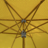 East London Parasol Company. Big Orange Aretha, stunning 3m wooden frame garden parasol. Natural waterproof cotton canvas with printed orange zig zags and yellow interior, with natural cotton tassels. The edges are an arabian-influenced shape. The canopy is removable. The ultimate garden decoration. Perfect show stopping garden umbrella for an elegant dining area or pool, or beside a sun lounger, for an event or wedding. Luxurious, flamboyant and colourful garden accessories.
