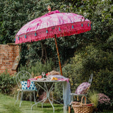 Pink Nina- waterproof canvas with pink and blue leaf design garden umbrella. Balinese garden parasol perfect for a picnic, patio, through your table with an umbrella hole or by your sun lounger at the pool. Very beautiful, colourful summer garden decorations. Make your outdoor space chic, elegant and glamorous with this colourful tasseled bali parasol..