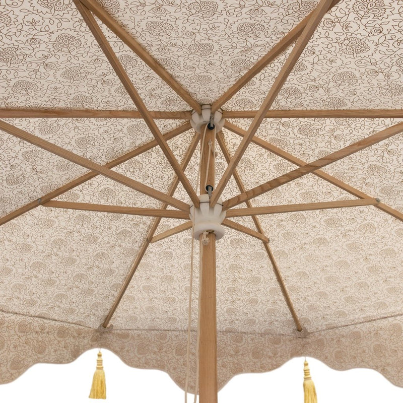 Big Liberace, stunning 3m wooden frame cream and gold garden parasol. Natural cotton canvas with gold block print inside and luxurious gold tassels. The edges are an arabian-influenced shape with handmade adornments. The canopy is removable. The ultimate garden decoration. Perfect show stopping garden umbrella for an elegant dining area or pool, or beside a sun lounger, for an event or wedding.