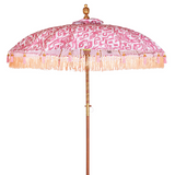 Sophia Round Bamboo Parasol's canopy is a glamorous digitally printed pink and white ikat print. Inside the threading is vibrant lemon yellow, and the fringe is a combination of coral fringing and pink tassels. The pole is made from hand-carved durian wood pole with gold paint and finial, the pole join and pegs are made from solid brass.