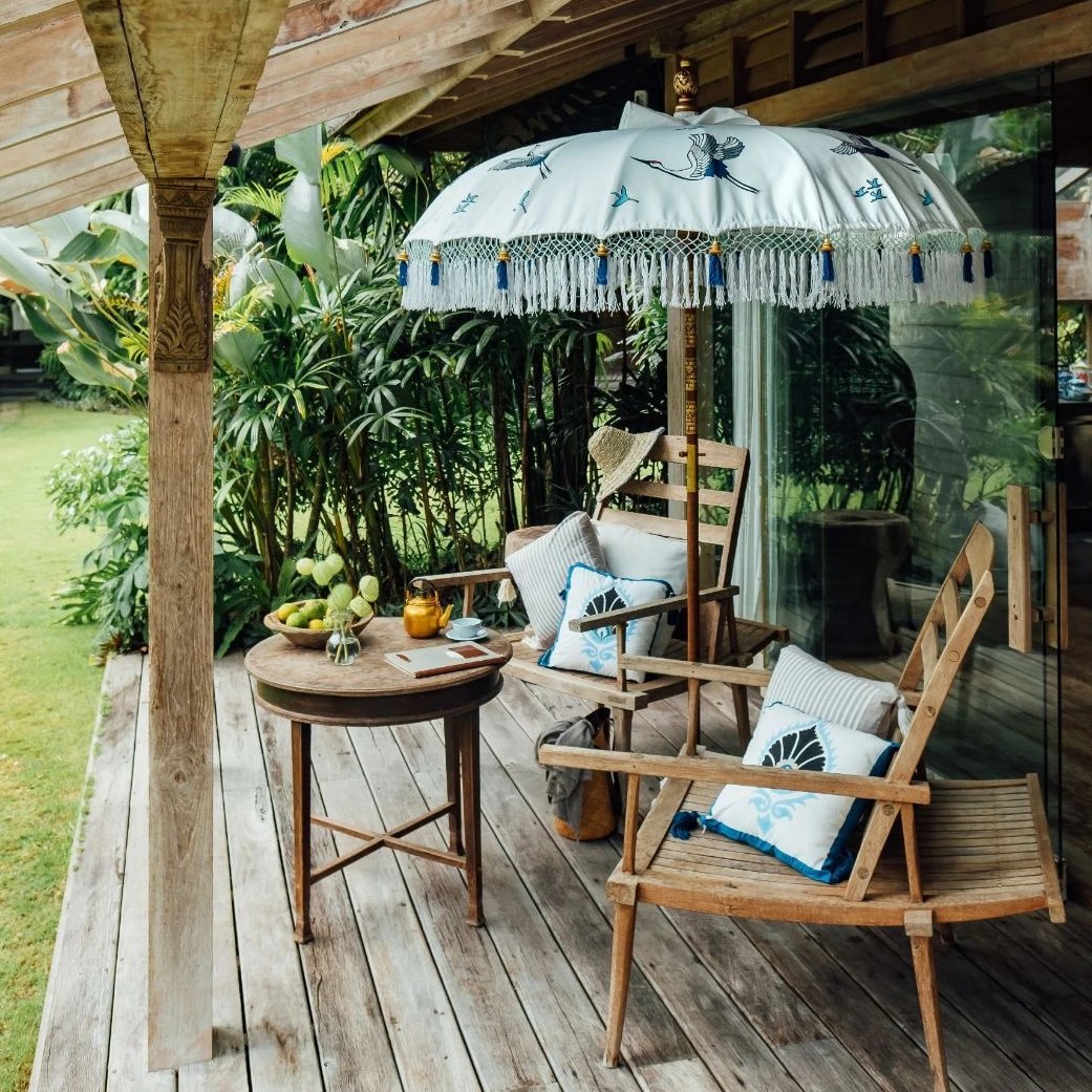 East London Parasol Company Bali Bamboo 2m garden umbrella. Flying birds cranes with white, blue and indigo. Handmade and handpainted with fringing and tassels in shades of white