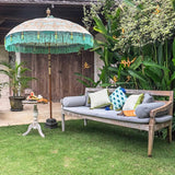 Gold, green and turquoise bali garden parasol. Handmade beautfiful colourful garden parasol made by East London Parasol Company. The most pretty parasol for a summer party or wedding.