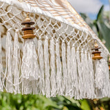 Big Simone- Cream white and gold garden handmade bali parasol with fringing pom poms and beads. A beautiful wooden bamboo 3 meter garden umbrella perfect for a picnic, patio, through your table with an umbrella hole or by your sun lounger at the pool. Make your outdoor space chic, elegant and glamorous with this boho and stylish garden parasol. The most pretty garden decoration for summer.