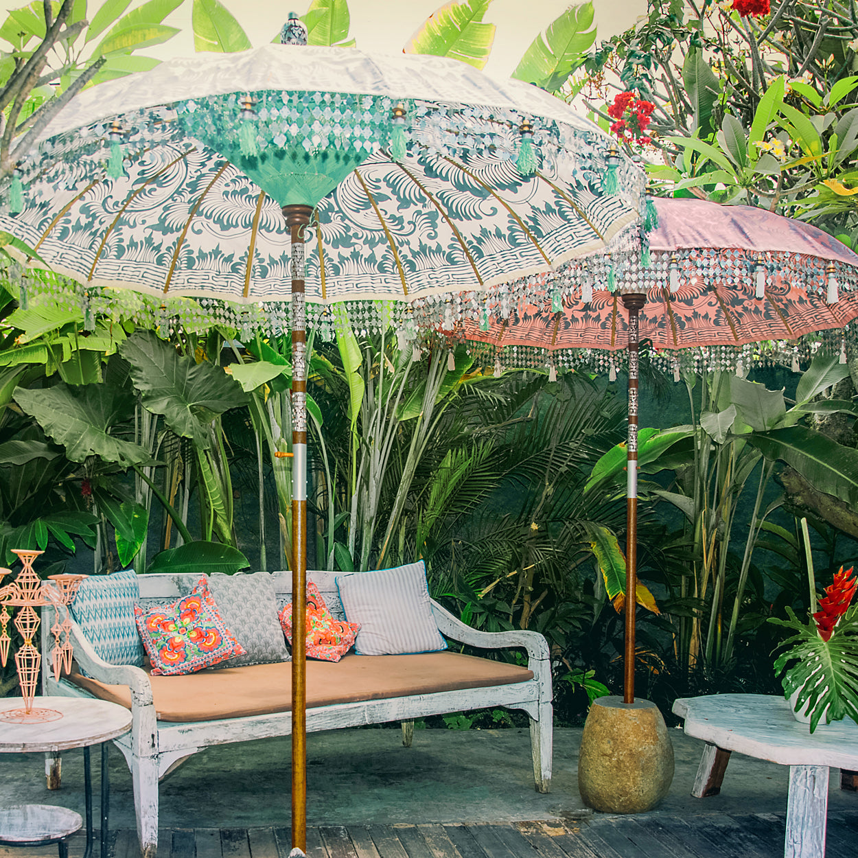 Stevie Round Bamboo Parasol- Pale pink twill garden parasol with floral design hand painted in silver ink. The pole is made from hand-carved durian wood pole with silver paint and finial, the pole join and pegs are made from solid brass with white threading, bamboo spokes.