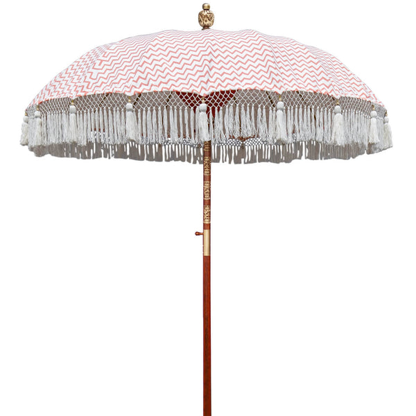 Kate Round Bamboo Parasol - Digitally printed coral zig zags and the interior is white taffeta with red threading. The fabric is waterproof canvas. The pole is made from hand-carved durian wood pole with gold paint and finial, the pole join and pegs are made from solid brass.. The fringing is white with extra large white cotton tassels.