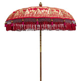 Olivia Round Bamboo Parasol -Scarlet red twill with lotus design hand-painted in gold ink. Pink threading inside and bamboo spokes. The pole is made from hand-carved durian wood pole with gold paint and finial, the pole join and pegs are made from solid brass. The fringing is in shades of red and dove grey with the most beautiful hot pink tassels.