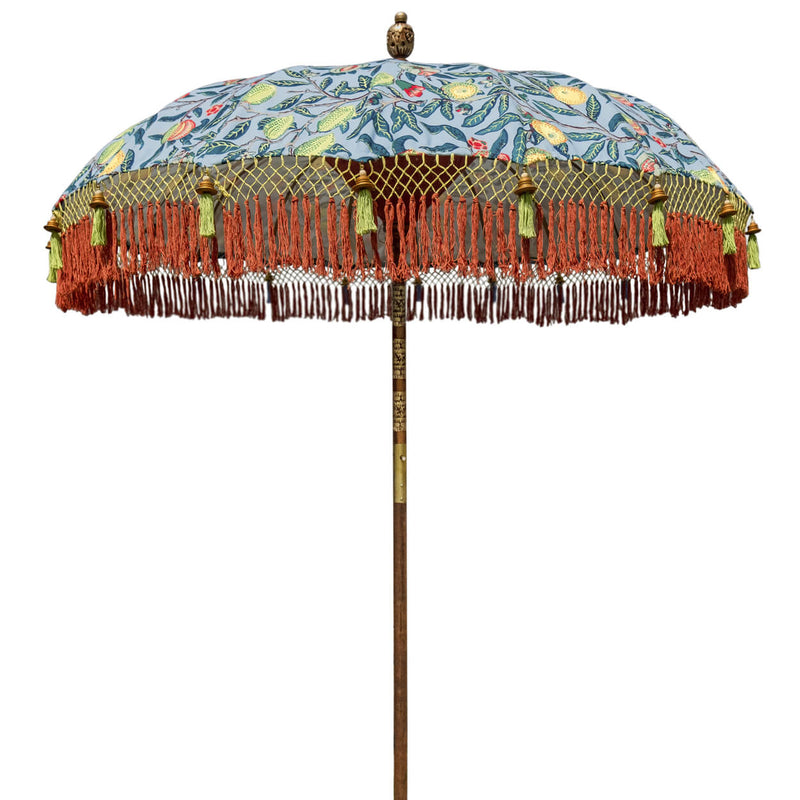 William Round Bamboo Parasol- Digitally printed William Morris print in our own colours. Waterproof canvas lined with white and with deep orange threading inside. The pole is made from hand-carved durian wood pole with gold paint and finial, the pole join and pegs are made from solid brass. The fringing is in shades of ochre, dark orange and dark purple blue with gold beading.